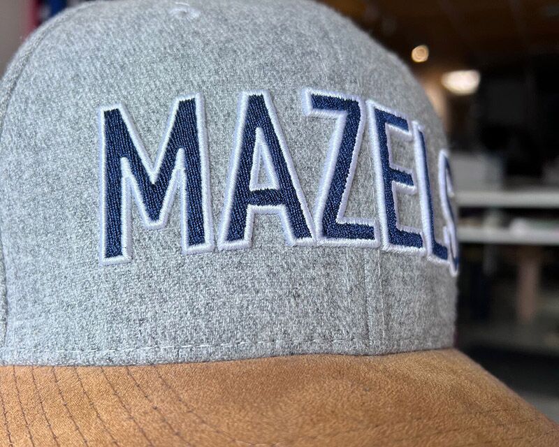 A cap that has been fully customized, including shape, material, and branding.